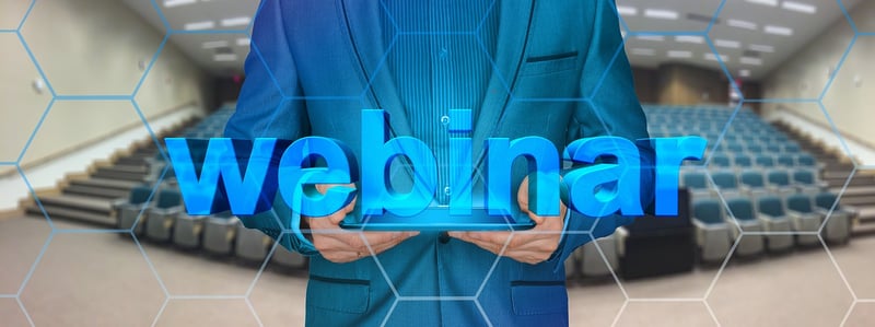 man-holding-sign-saying-webinar