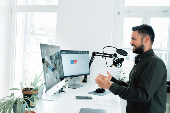 man-standing-in-front-of-2-monitors